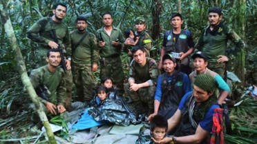 FILE - In this photo released by Colombia's Armed Forces Press Office, soldiers and Indigenous men pose for a photo with the four children who were missing after surviving a deadly plane crash, in the Solano jungle, Caqueta state, Colombia, June 9, 2023. (Colombia's Armed Force Press Office via AP, File)   Photo Details