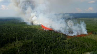 This July 24, 2023, handout image released by the British Columbia Wildfire Service, shows a fire fighting aircraft battling the Townsend Creek wildfire, soth of Baker Creek, British Columbia, Canada. (AFP)