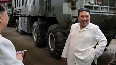 In this undated photo provided on Monday, Aug. 14, 2023, by the North Korean government, North Korean leader Kim Jong Un, right, smiles in front of a military vehicle, during his Aug. 11-12 visit to a military factory in North Korea. (AP)