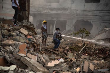Firefighters put out a fire after a powerful explosion in San Cristobal, Dominican Republic, Monday, Aug 14, 2023. (AP)