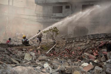 Firefighters put out a fire after a powerful explosion in San Cristobal, Dominican Republic, Monday, Aug 14, 2023. (AP)