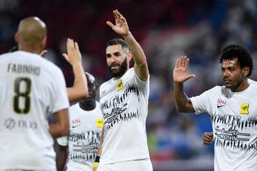 Ittihad's French forward #09 Karim Benzema celebrates with team mates after they won the Saudi Pro League football match between Al-Raed and Al-Ittihad at the King Abdullah Sports City stadium in Buraidah on August 14, 2023. (Photo by AFP)