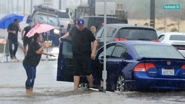 Motorists deal with a flooded road and stuck vehichles during heavy rains from Tropical Storm Hilary in Palm Springs, California, on August 20, 2023. (Reuters)