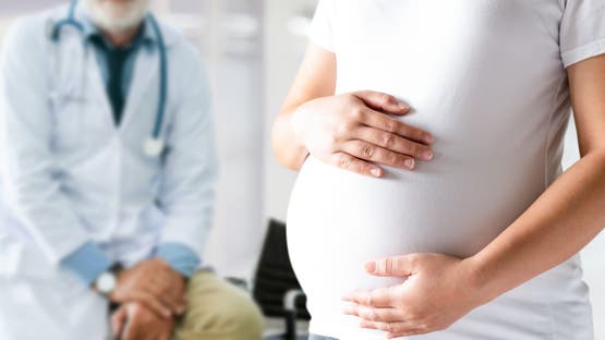 Pregnant Woman and Gynecologist Doctor at Hospital stock photo