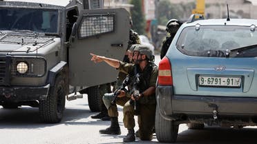 Israeli troops guard, at the scene of a shooting, near Hebron, in the Israeli-occupied West Bank on August 21, 2023. (Reuters)