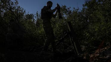 A Ukrainian service member prepares a mine to fire a mortar at their position at a front line, amid Russia's attack on Ukraine, near the city of Bakhmut in Donetsk region, Ukraine August 7, 2023. REUTERS/Oleksandr Ratushniak
