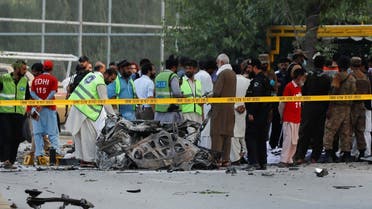 Army soldiers, police officers and rescue workers gather at the site of a suicide attack near a paramilitary force vehicle in Peshawar, Pakistan, on July 18, 2023. (Reuters)
