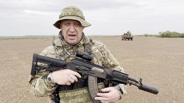 Yevgeny Prigozhin, chief of Russian private mercenary group Wagner, gives an address in camouflage and with a weapon in his hands in a desert area at an unknown location, in this still image taken from video possibly shot in Africa and published August 21, 2023. (Reuters)