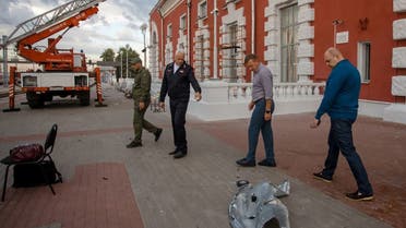 This photograph posted on August 20, 2023 on the official Telegram account of Roman Starovoit, Kursk region governor, shows Roman Starovoit (2nd R) inspecting an area outside a damaged railway station building following a drone attack in Kursk. (AFP)