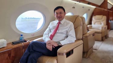 Former Thai Prime Minister Thaksin Shinawatra, who is expected to be arrested upon his return as he ends almost two decades of self-imposed exile, is pictured inside a plane at an unknown location in this still image released on August 22, 2023. (Reuters)