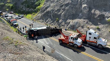Tow trucks and authorities work at the area of a road accident, which left over a dozen dead, in Tepelmeme Villa de Morelos, in Oaxaca state, Mexico August 22, 2023. (Reuters)