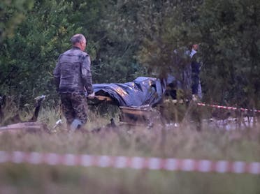 Emergency specialists carry a body bag near wreckages of the private jet linked to Wagner mercenary chief Yevgeny Prigozhin at the crash site in the Tver region, Russia, August 24, 2023. (Reuters)