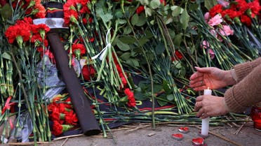 A view shows a sledgehammer with Wagner logo among flowers at a makeshift memorial near former PMC Wagner Center, associated with the founder of the Wagner Group, Yevgeny Prigozhin, in Saint Petersburg, Russia, on August 24, 2023. (Reuters)