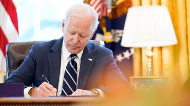 FILE - President Joe Biden signs the American Rescue Plan, a coronavirus relief package, in the Oval Office of the White House, March 11, 2021, in Washington. Federal officials estimate that local governments now have spending plans in place for most of the money they received under a prominent pandemic relief law. In some cases, it's hard to know exactly how the money is being used, because some governments haven't supplied details about their projects. (AP Photo/Andrew Harnik, File)