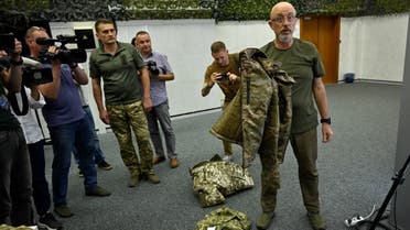 Ukraine's Minister of Defense Oleksiy Reznikov (R) shows Ukrainian military uniforms to the medias during a press conference in Kyiv, on August 28, 2023, amid the Russian invasion of Ukraine. (AFP)