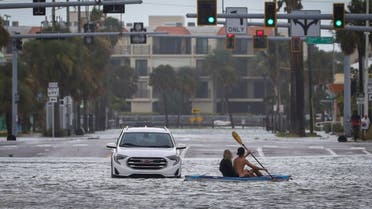 People kayak past an abandon vehicle in the intersection of Boca Ciega Drive and Pasadena Avenue Wednesday, Aug. 30, 2023 in St. Pete Beach, Fla., Hurricane Idalia made landfall Wednesday in Florida as a Category 3 storm and unleashed devastation along a wide stretch of the Gulf Coast, submerging homes and vehicles, turning streets into rivers, unmooring small boats and downing power lines in an area that has never before received such a pummeling. (AP)
