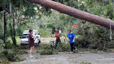 From left; residents Alana Hall, Kayci Carter, and Tracy Hall clean up debris caused by Hurricane Idalia in front of their home Wednesday, Aug. 30, 2023, in Perry, Fla. (AP)