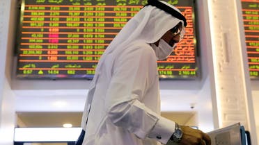 An investor walks through the Dubai Financial Market in Dubai
