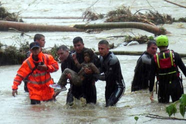 Emergency team members rescue a young girl during floods in a campsite in Kirklareli province, Turkey, Tuesday, Sept. 5, 2023. (AP)