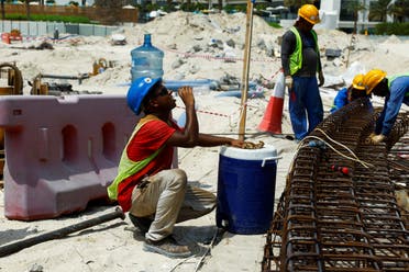 A worker drinks water as he works at a construction site, as the UAE implements a midday work break from 12.30pm to 3.30pm for laborers to help them cope with the heat, in Dubai, United Arab Emirates, August 15, 2023. (Reuters)