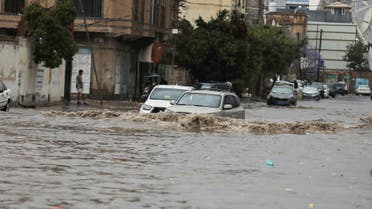 Women stand on the pavement of a flooded street during heavy rains in Sanaa, Yemen, March 29, 2023. REUTERS/Khaled Abdullah