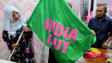 A Progressive Party of Maldives worker poses with an India Out flag in Male, Maldives, March 21, 2022. (File photo: Reuters)