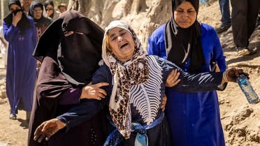 A woman is helped as she reacts to the death of relatives in an earthquake in the mountain village of Tafeghaghte, southwest of Marrakesh, on September 10, 2023. (AFP)