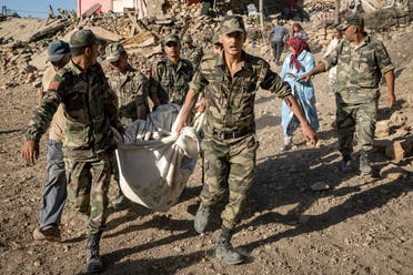 Moroccan Royal Armed Forces evacuate a body from a house destroyed in an earthquake in the mountain village of Tafeghaghte, southwest of the city of Marrakesh, on September 9, 2023. (AFP)