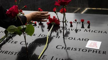 Relatives of the victims place flowers at the September 11 Memorial in New York City (AFP)