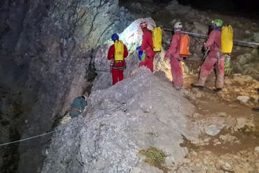 Members of the CNSAS, Italian alpine and speleological rescuers, start to descent on ropes the Morca cave during a rescue operation near Anamur, south Turkey, Monday, Sept. 11, 2023. (AP)