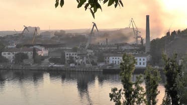 Smoke rises from the shipyard that was reportedly hit by Ukrainian missile attack in Sevastopol, Crimea, in this still image from a video taken on September 13, 2023. (Reuters)