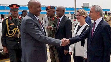 This handout image posted on the Sudanese Transitional Council’s official Facebook page on September 13, 2023, shows army chief General Abdel Fattah al-Burhan (2nd-L) shaking hands with officials prior to departure from Port Sudan International Airport for a visit to Turkey. (AFP)