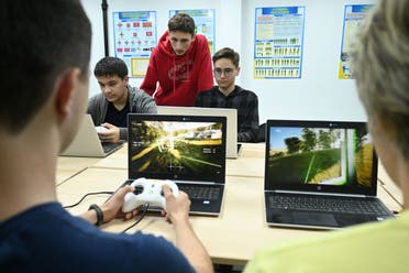 Boys learn to fly a drone using simulators during a lesson at the military-patriotic center for schoolchildren in Lviv on September 14, 2023. (AFP)