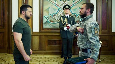 In this handout photograph taken and released by Ukrainian Presidential Press Service on September 14, 2023 Ukraine's President Volodymyr Zelensky (L) gives an award to a serviceman during a ceremony marking Tank Troops Day in Kyiv. (AFP)