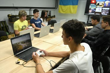 Schoolchildren learn to fly a drone using simulators during a lesson at the military-patriotic center in Lviv on September 14, 2023. (AFP)