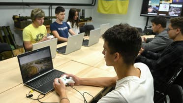 Schoolchildren learn to fly a drone using simulators during a lesson at the military-patriotic center in Lviv on September 14, 2023. (AFP)