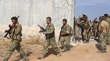 Pro-Turkish Syrian fighters cross the border into Syria as they take part in an offensive against Kurdish-controlled areas in northeastern Syria launched by the Turkish military, on October 11, 2019. (AFP)