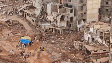 Rescue teams look for flash flood victims in the city of Derna, Libya, Monday, Sept. 18, 2023. Mediterranean storm Daniel caused flooding that overwhelmed two dams, sending a wall of water through the city. More than 10,000 were killed, and another 10,000 are missing. (AP Photo/Yousef Murad)