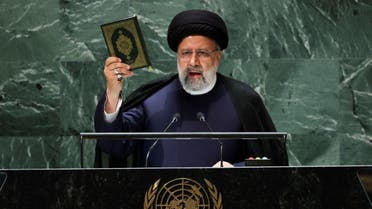 Iran's President Ebrahim Raisi holds up the holy book of Quran as he addresses the 78th Session of the U.N. General Assembly in New York City, U.S., September 19, 2023. (Reuters)