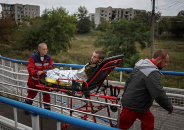 Health workers transport a wounded Ukrainian serviceman, as Russia's attack on Ukraine continues, in the town of Izium, recently liberated by Ukrainian Armed Forces, in Kharkiv region, Ukraine September 14, 2022. (Reuters)