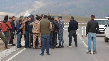 People gather near the Armenian border guard post on the road leading from Armenia to Azerbaijan's Nagorno-Karabakh region, near the village of Kornidzor, Armenia September 21, 2023.