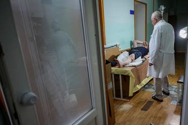 A doctor examines a man, who was wounded during a Russian strike, before a surgery, amid Russia's attack on Ukraine, in Kherson, Ukraine, June 8, 2023. (Reuters)