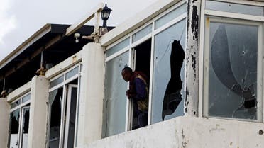 A Somali police officer looks from the broken windows of the Pearl Beach Restaurant following an attack by al-Shabaab militants at the Liido beach in Mogadishu, Somalia, on June 10, 2023. (Reuters)
