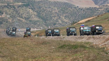 Vehicles of Russian peacekeepers leaving Azerbaijan's Nagorno-Karabakh region for Armenia pass an Armenian checkpoint on a road near the village of Kornidzor, Armenia September 22, 2023. REUTERS/Irakli Gedenidze