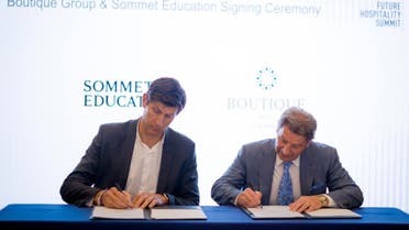 The CEO of Boutique Group Mark De Cocinis and the CEO of Sommet Education Benoit-Etienne Domenget signing an MoU in Abu Dhabi. (Supplied)