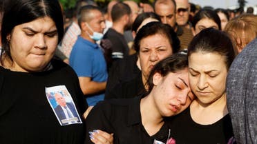 Mourners react during the funeral of victims of the fatal fire of a wedding celebration, in Hamdaniya, Iraq, September 27, 2023. (Reuters)