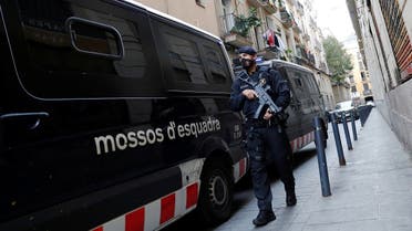 A police officer stands guard on the street in the El Raval neighborhood of Barcelona, Spain. (File photo: Reuters)