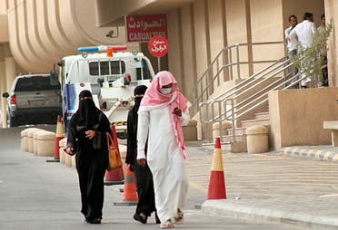 A man and a woman walk near a hospital in Khobar city in Dammam, Saudi Arabia. (Reuters)