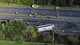 Bus overturns in England, kills driver and 14-year-old