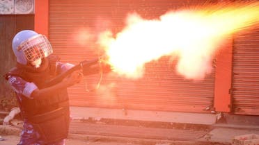 A riot police officer fires a tear smoke shell to disperse demonstrators protesting against the killing of two Meitei students in Imphal, Manipur, India, September 27, 2023. (Reuters)